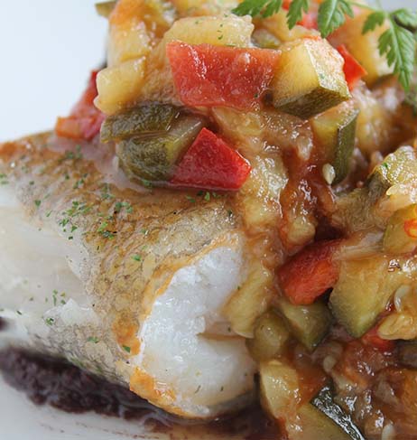 Cod with ratatouille on top of it